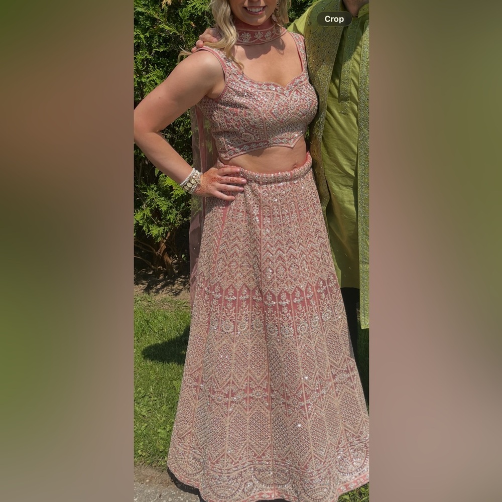 Lehenga set , peachy pink colour with reflective details.